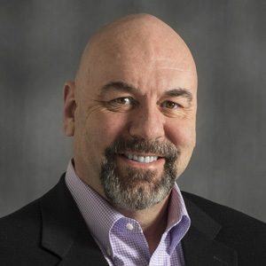 Bald man with a beard smiling