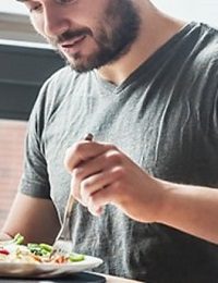 Person eating salad with fork