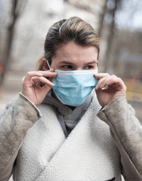 Person wearing a blue medical mask