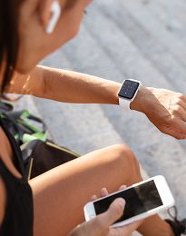 Fitness enthusiast with smartwatch and earbuds