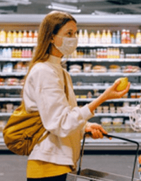 Woman shopping for groceries in mask
