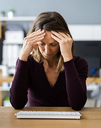 Overwhelmed person with keyboard nearby