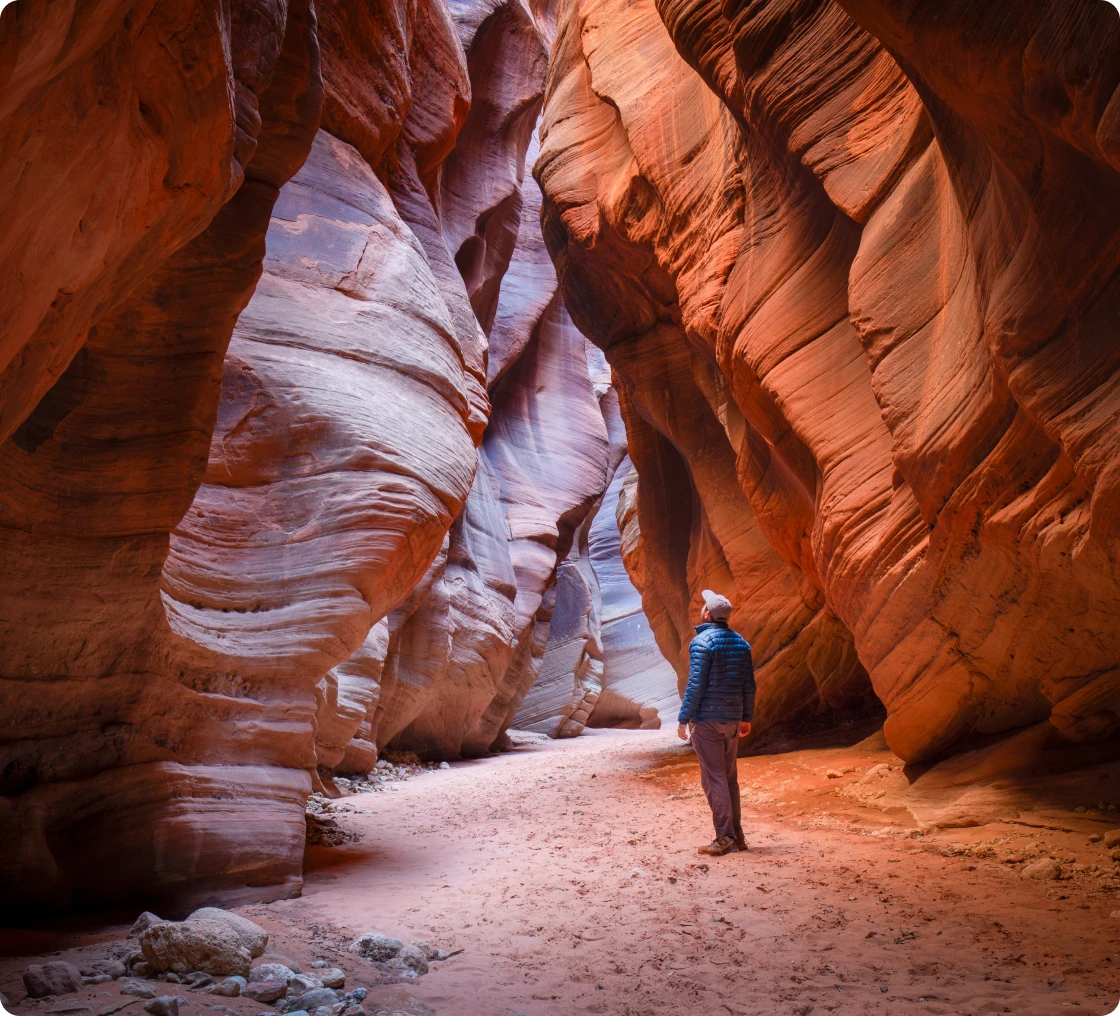 Hiker in narrow red rock canyon