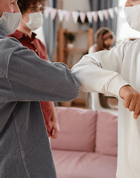 People greeting with elbow bump