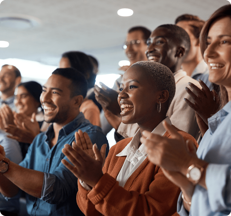 Smiling audience clapping hands