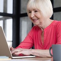 Senior woman typing on a laptop