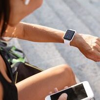 Fitness enthusiast with smartwatch and earbuds